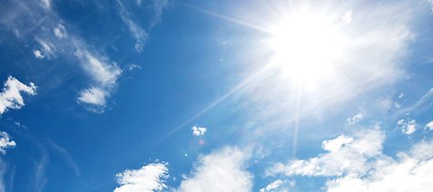 Blå himmel och solen som strålar.